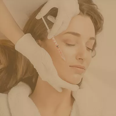 Woman getting facial cosmetic injection at a beauty clinic